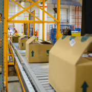 cartons on a conveyor belt in a warehouse