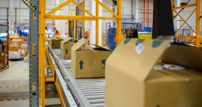 cartons on a conveyor belt in a warehouse