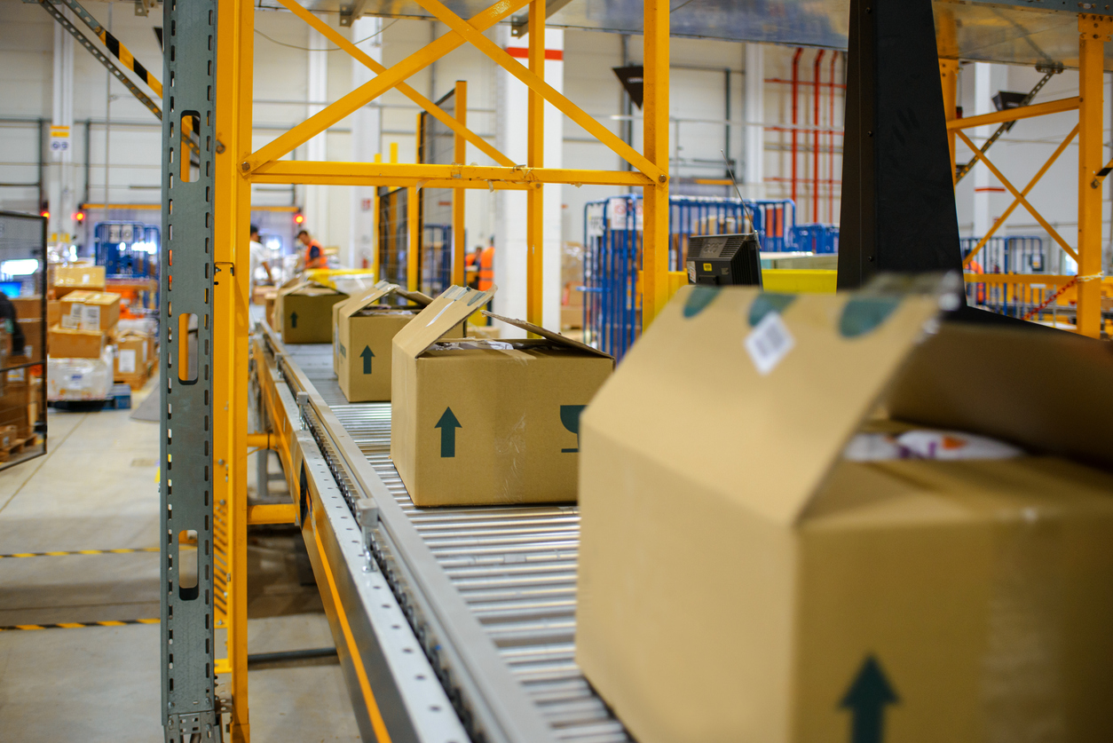 cartons on a conveyor belt in a warehouse